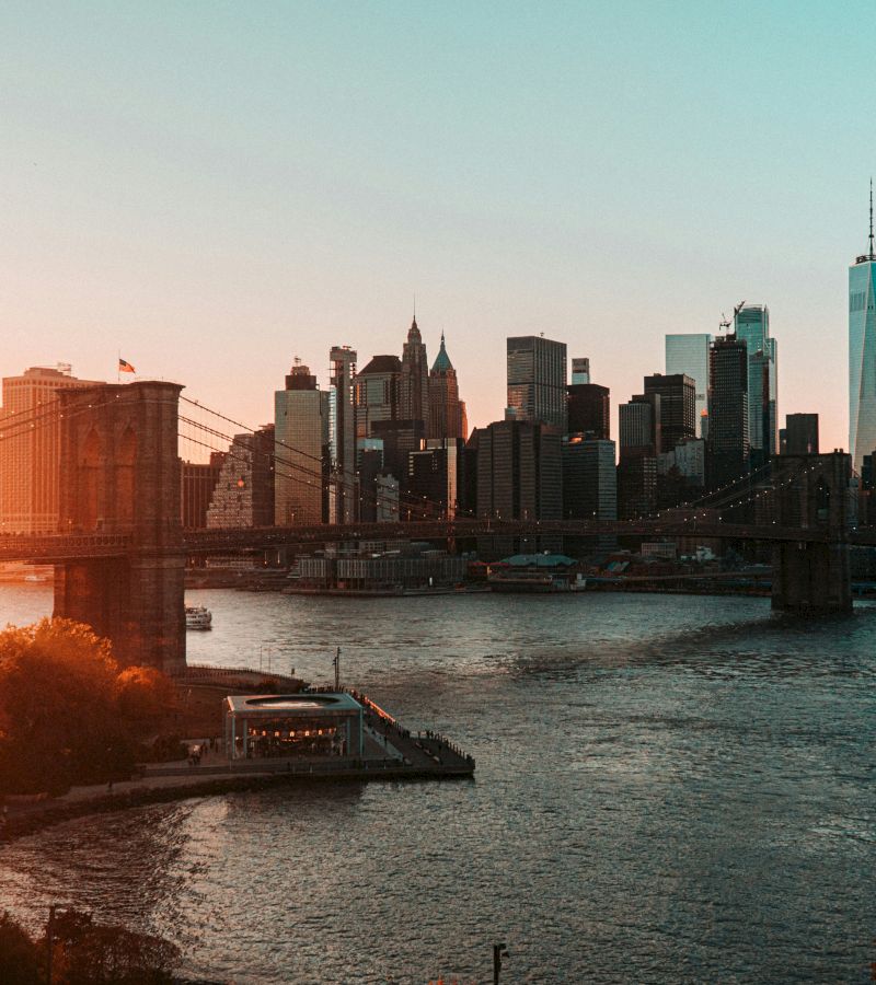 A city skyline with a bridge over water